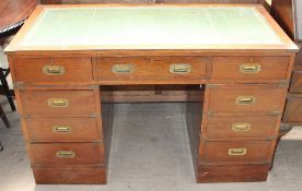 A reproduction mahogany pedestal desk with a leather inset top,