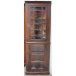 A 20th century oak standing corner cupboard,