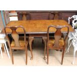 A 20th century walnut extending dining table and four chairs