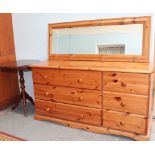 A pine chest of drawers together with a pine wall mirror and an inlaid table