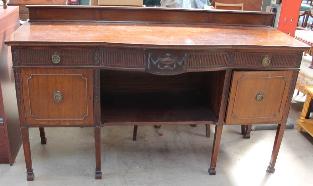 A 20th century mahogany sideboard with drawers and cupboards on square legs and square feet