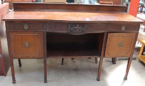 A 20th century mahogany sideboard with drawers and cupboards on square legs and square feet