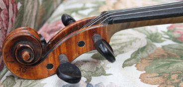 A violin with a one piece back and ebonised stringing, bears a label,