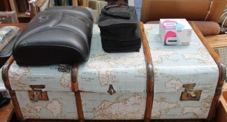 A banded trunk decorated with map material together with a massage cushion,