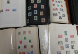 A collection of stamp albums including world stamps from the early decades of the 20th century