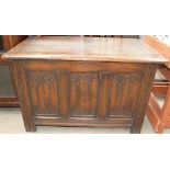 A 20th century oak coffer with a three panelled linen fold front