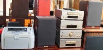 A Denon stacking system together with speakers, computer keyboard, computer speakers,