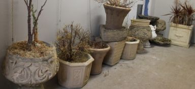 A collection of reconstituted stone planters, bird bath,