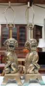 A pair of cast brass dog of foo table lamps