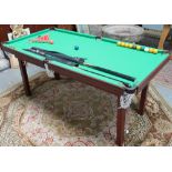 A quarter size snooker table together with cues and balls
