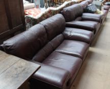 A leather three-piece suite comprising a three seater settee,