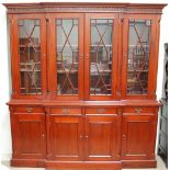 A modern wall unit the top with a moulded cornice above four glazed doors,