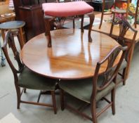 A reproduction mahogany circular dining table together with a set of four Hepplewhite style chairs