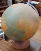 An electrified globe on a turned wooden base
