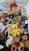 An assortment of teddy bears and dolls