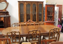 A modern extending dining table and five matching chairs, together with a wall unit,
