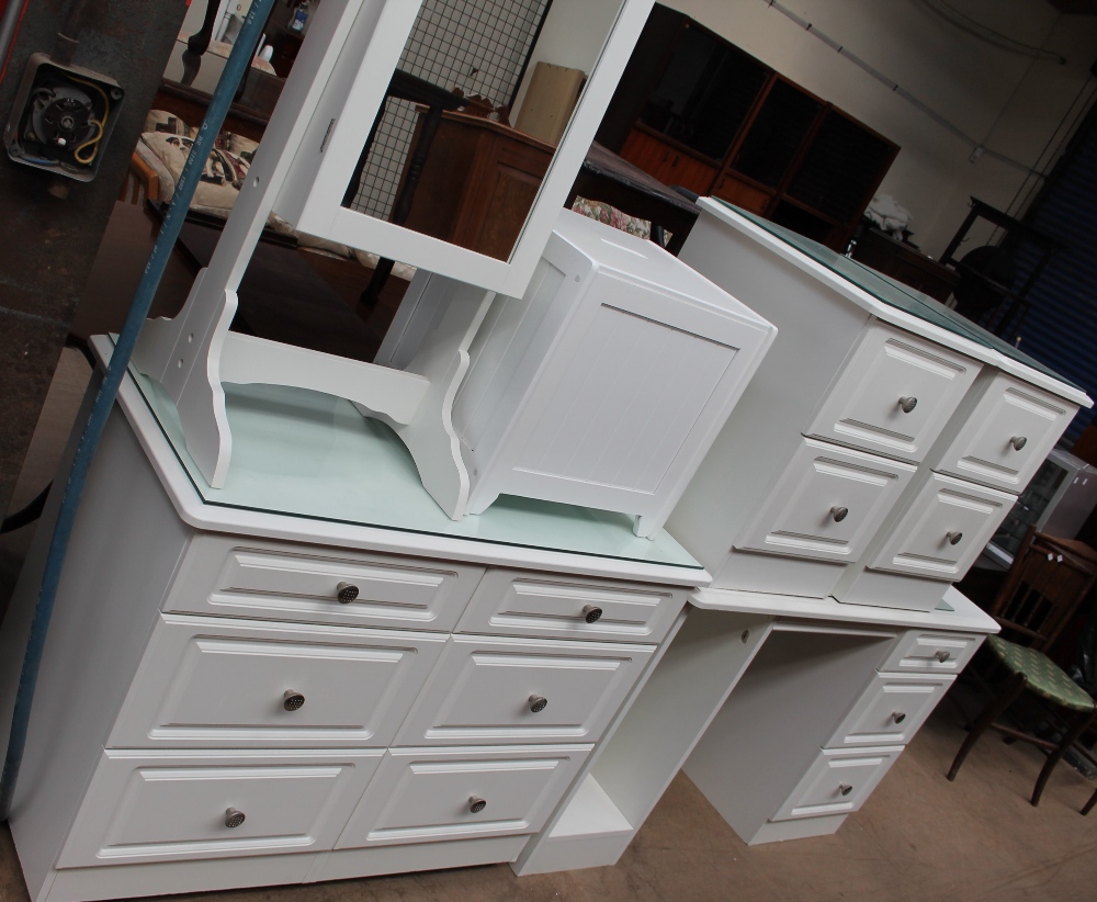 A modern chest of drawers together with a matching pair of bedside cabinets, a desk,