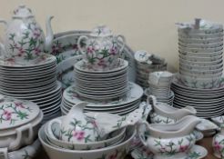 A Chinese porcelain part dinner service transfer and infil decorated with a plum blossom decoration