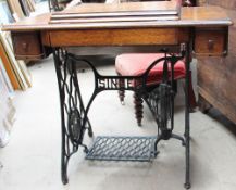 A Singer sewing machine table with oak top and cast-iron base