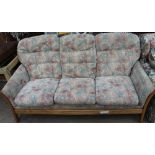 An Ercol upholstered three-seater settee