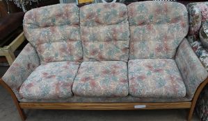 An Ercol upholstered three-seater settee