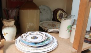 A stoneware storage jar together with assorted plates, barometer, clock,