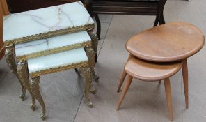 A nest of two Ercol pebble tables together with an onyx and brass nest of three tables and a piano