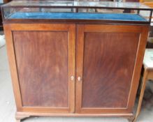 A mahogany side cabinet with a display cabinet applied to the top