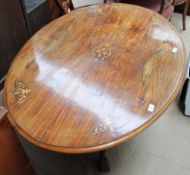 A Victorian walnut inlaid oval topped supper table
