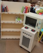 A painted nursery bookcase with children's books, a toy microwave oven,