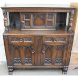 A 20th century oak court cupboard with a central cupboard,