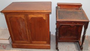 An Edwardian Davenport with a raised stationery box and inkwells,