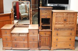 A 20th century oak dressing table with three banks of drawers together with a matching tallboy a