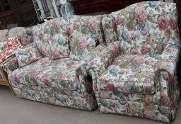 An upholstered two seater sofa bed together with a matching arm chair