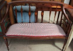 An Edwardian mahogany two-seater settee with vase shaped splats and pad seat