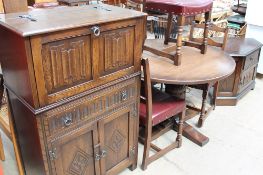A 20th century oak dining table, four chairs,
