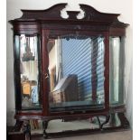 An Edwardian mahogany hanging display cabinet with a shaped cornice,