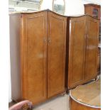 A 20th century walnut four-piece bedroom suite with two double wardrobes,