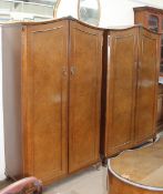 A 20th century walnut four-piece bedroom suite with two double wardrobes,