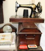 A cased singer sewing machine together with a mantle clock, tins,