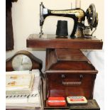 A cased singer sewing machine together with a mantle clock, tins,