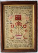 A Victorian woolwork sampler depicting a house, vase of flowers, angels,