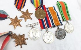 Three World War I medals including the War Medal, Victory Medal and 1914-15 Star,