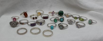 A silver ring set with an amethyst together with a collection of silver and semi precious stone set