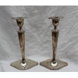 A pair of George V silver candlesticks,