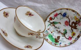 A Swansea porcelain cup and saucer decorated with puce flower heads with gilt leaves,