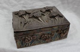 An Art Nouveau white metal cigarette box and cover embossed with flowers and bullrushes,