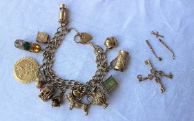 A 9ct yellow gold charm bracelet, set with numerous charms including a tankard, terrier, jug, heart,