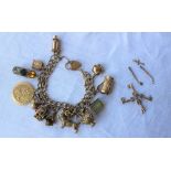 A 9ct yellow gold charm bracelet, set with numerous charms including a tankard, terrier, jug, heart,