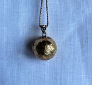 A 9ct yellow gold globe shaped hinged locket on a 9ct gold box link necklace,